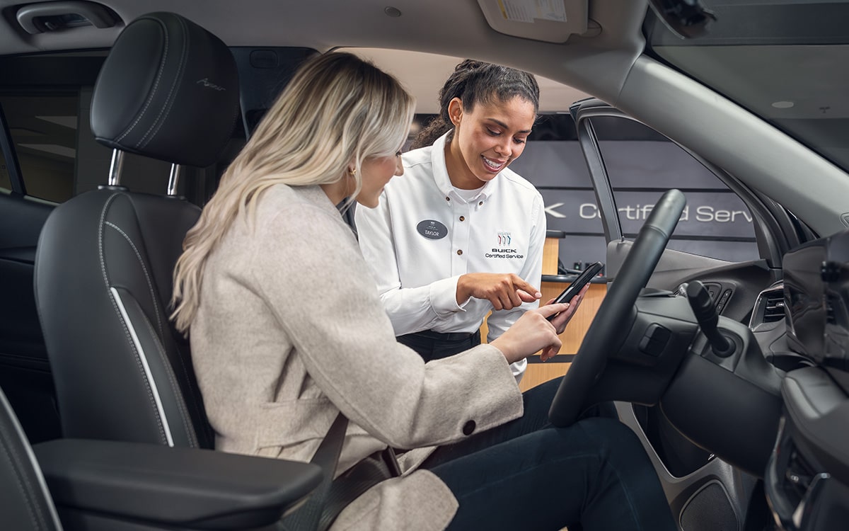 A Mechanic Is Placing a Filter in the Engine of a Chevrolet Vehicle