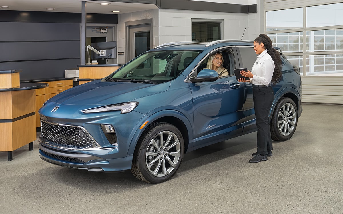 A Man Is Holding a Windshield Wiper for a Closer Inspection