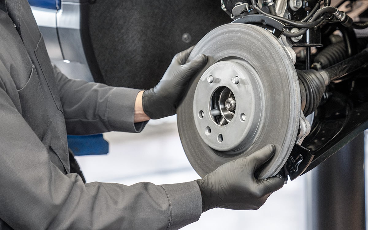 A Buick Certified Service Technician Installing a Battery