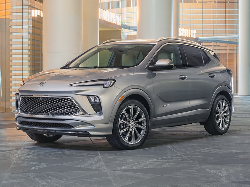 Front Three-Quarters View of a 2025 Encore GX Avenir Luxury Crossover in a Showroom