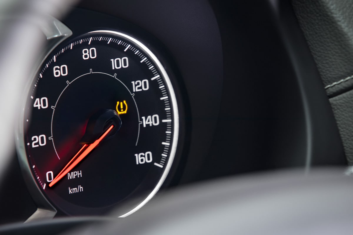 A Tire Pressure Light Lit Up on a Vehicle's Speedometer