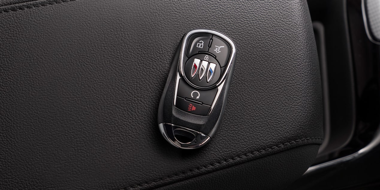 Car Fob Laying on the Center Console in a Vehicle Next to a My Buick Rewards Card