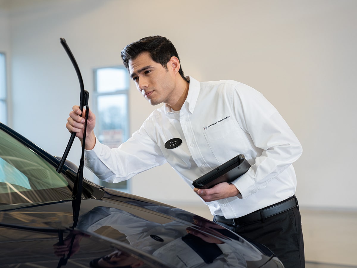 A Buick Certified Service Representative Inspecting a Buick Vehicle