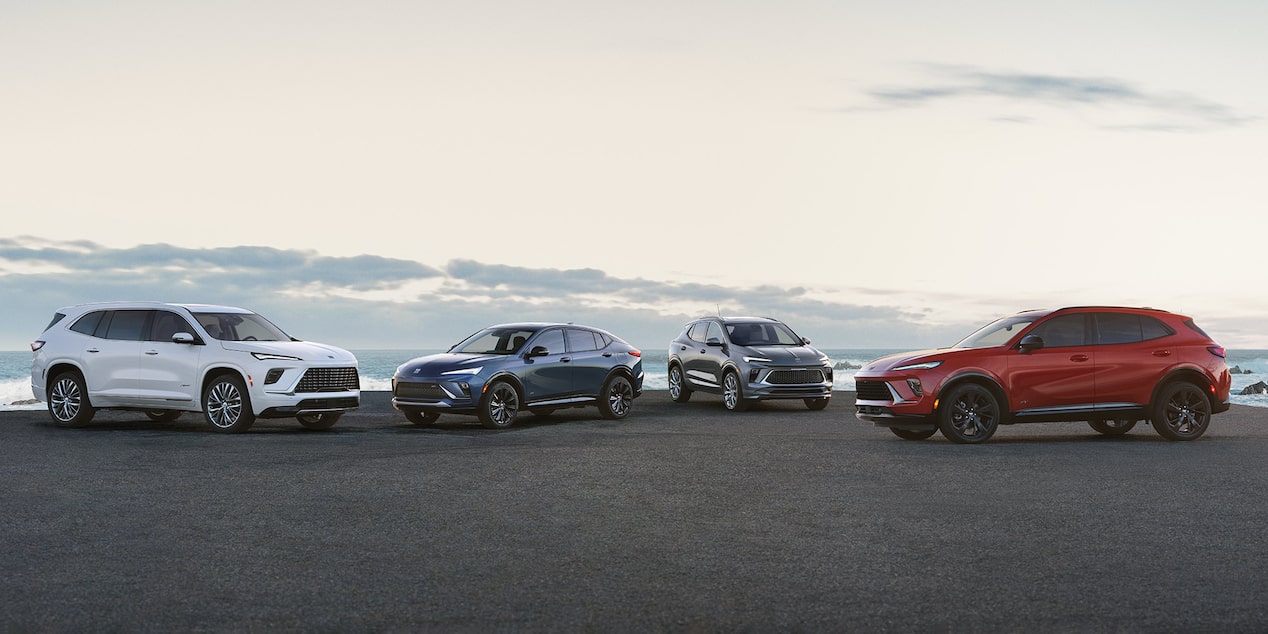 The 2025 Buick SUV Lineup Parked on a Beach at Sunset