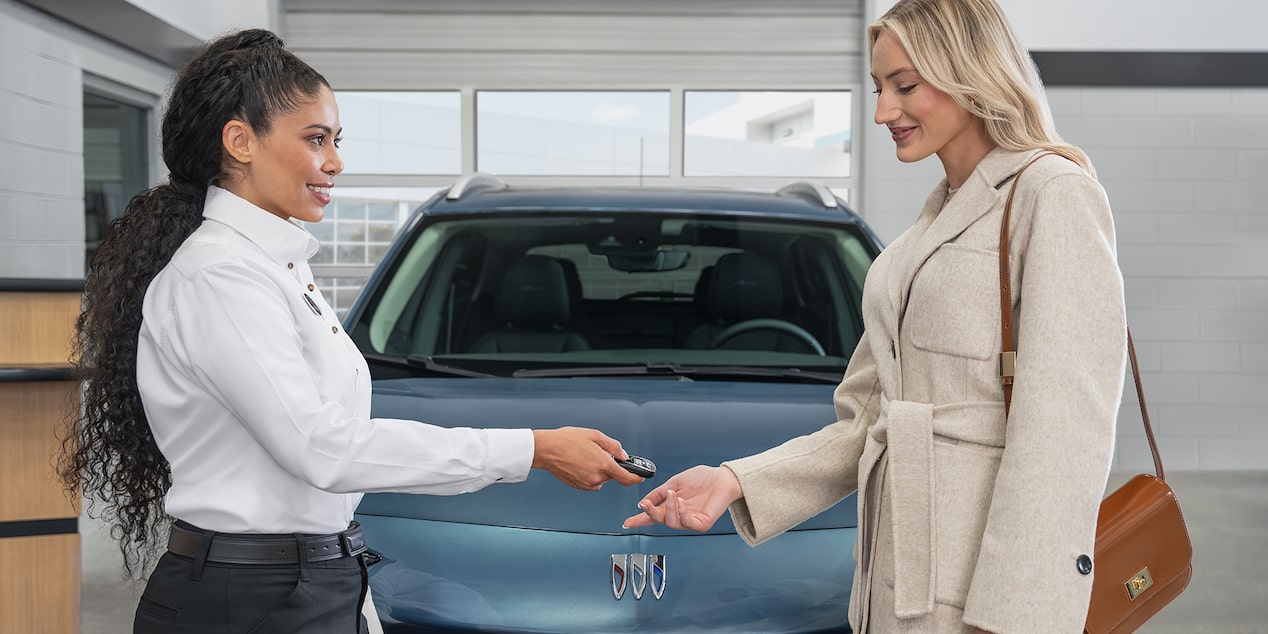 Buick Certified Service Technician Talking to a Buick Customer Sitting in His Vehicle