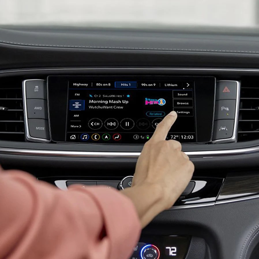 A Woman Using the Buick Infotainment System within Her Buick Vehicle