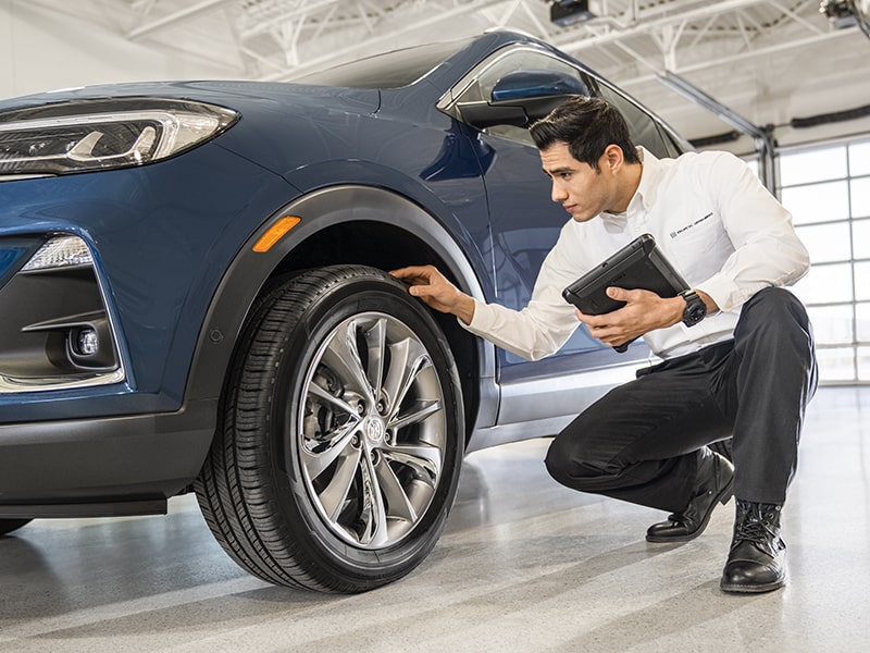 Certified Service Technician looking at Encore GX Wheel