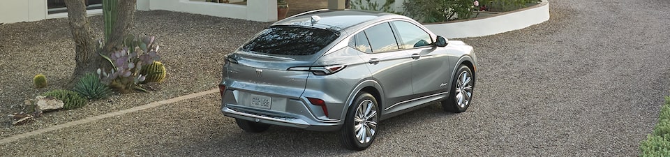 Grey buick suv parked on gravel road