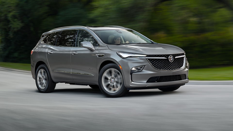 Buick SUV Driving on Empty Road Through the Trees