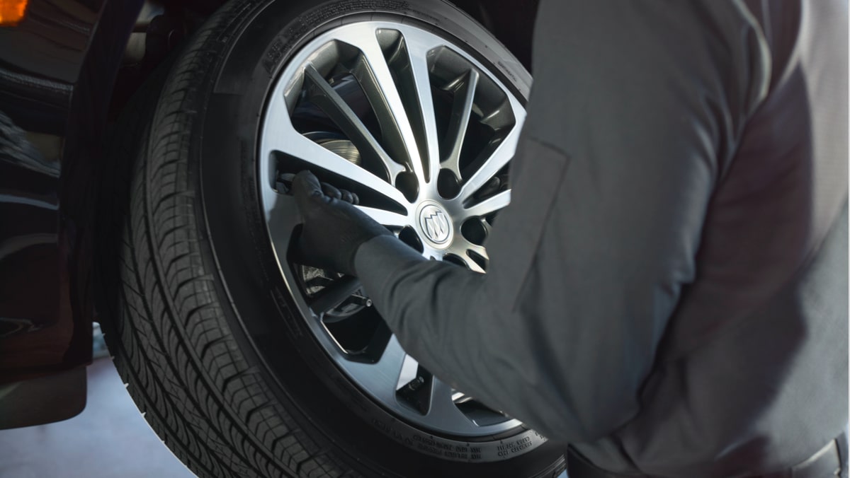 Buick Protection Service Expert Checking Tire