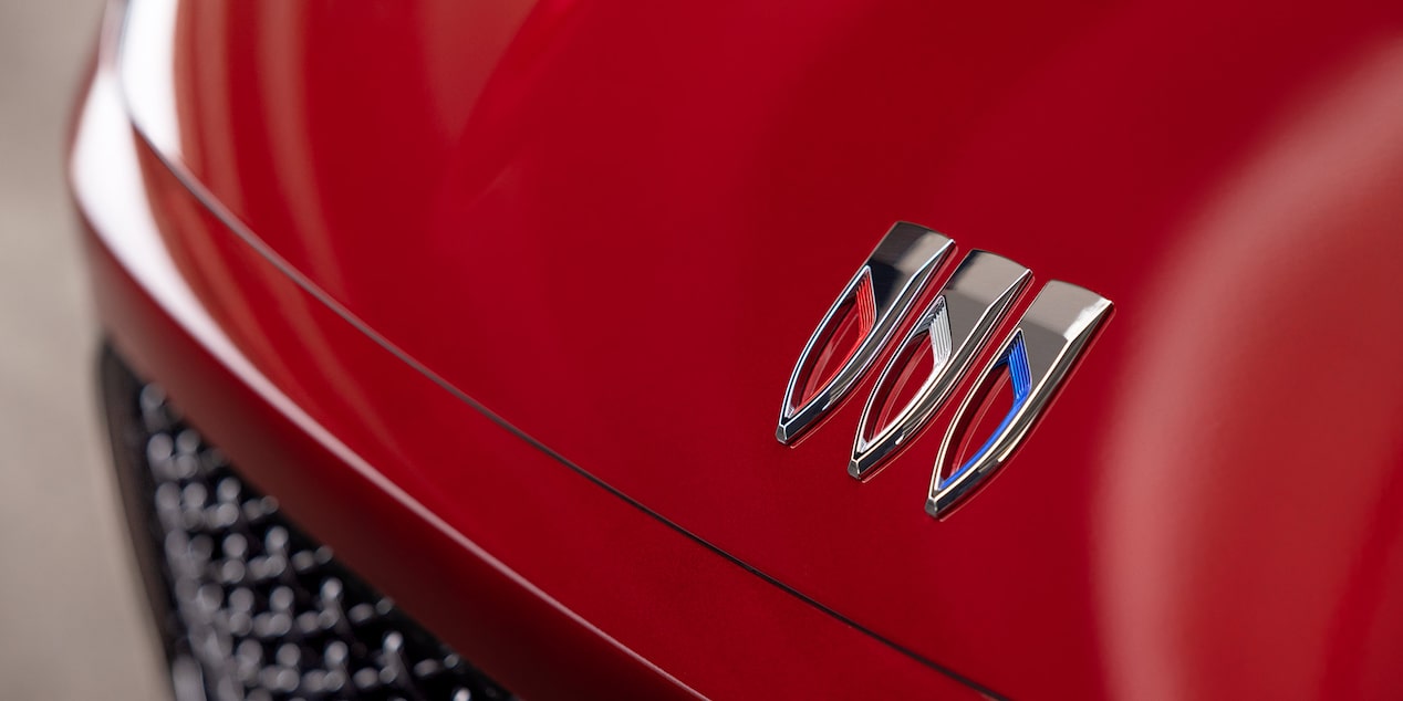 Close-up of the Emblem on the Hood of a Red 2026 Buick Enclave
