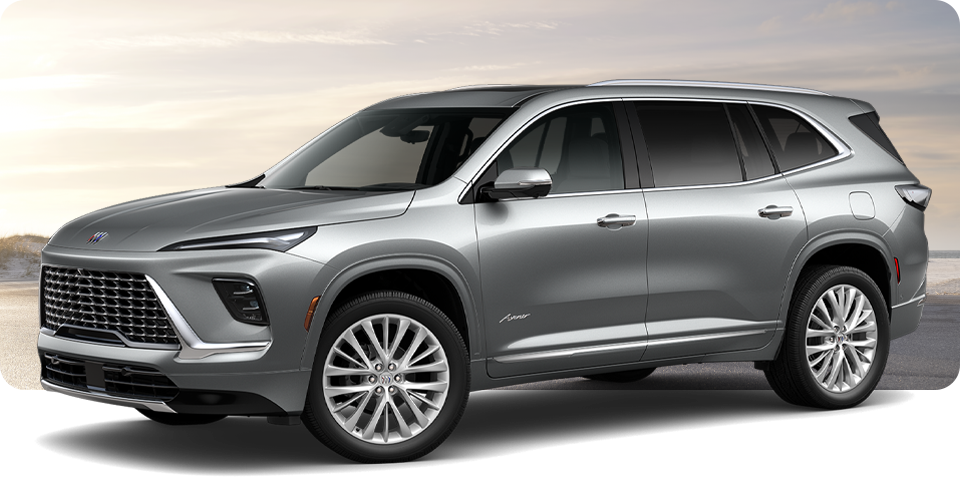 Front-Three Quarter View of a Silver Buick Enclave Avenir Luxury Mid-Size SUV Parked Near a Beach